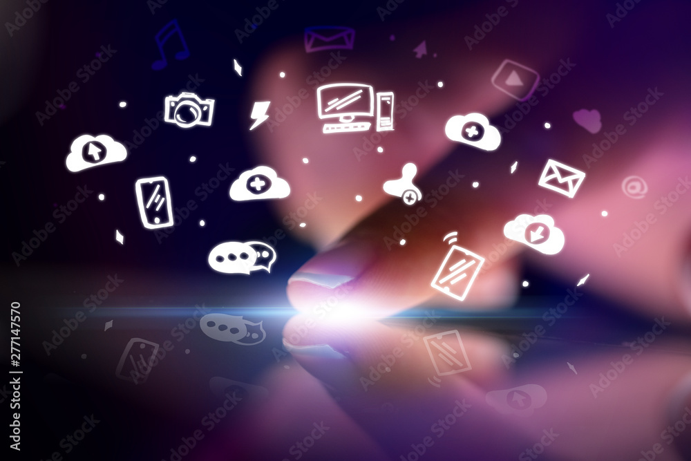 © ra2 studio - Finger touching tablet with white drawn application icons and dark background © ra2 studio - Finger touching tablet with white drawn application icons and dark background