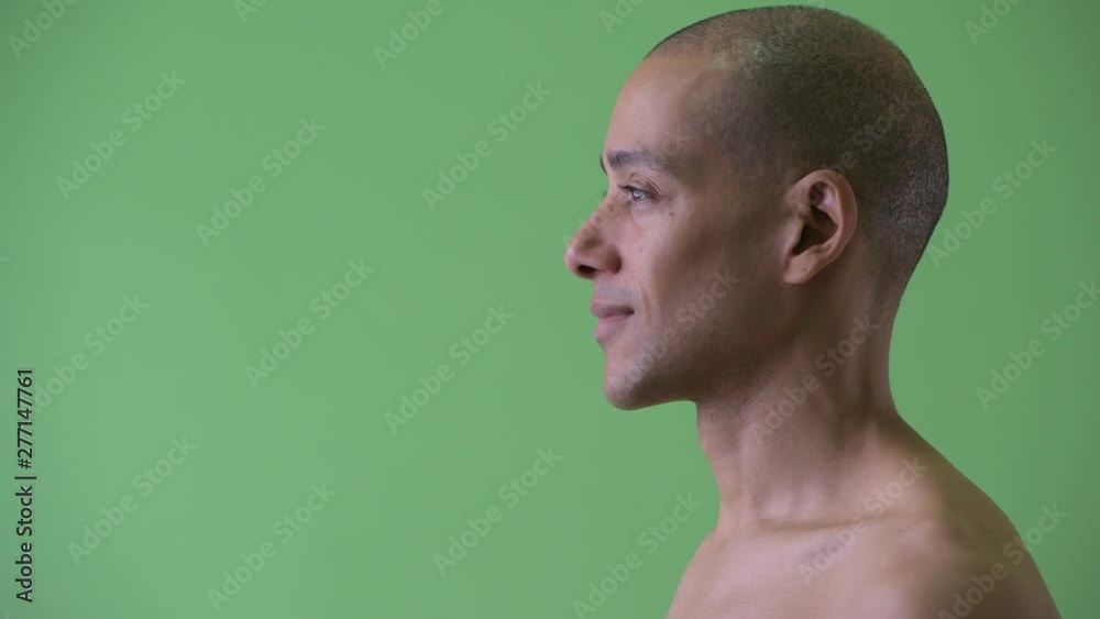 Closeup profile view of happy bald multi ethnic shirtless man smiling Closeup profile view of happy bald multi ethnic shirtless man smiling