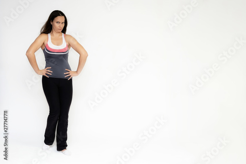 Fototapeta Naklejka Na Ścianę i Meble -  Full-length portrait on white background of beautiful pretty fitness girl woman in sports uniform, sitting on the stairs with different emotions in different poses. Stylish trendy youth.