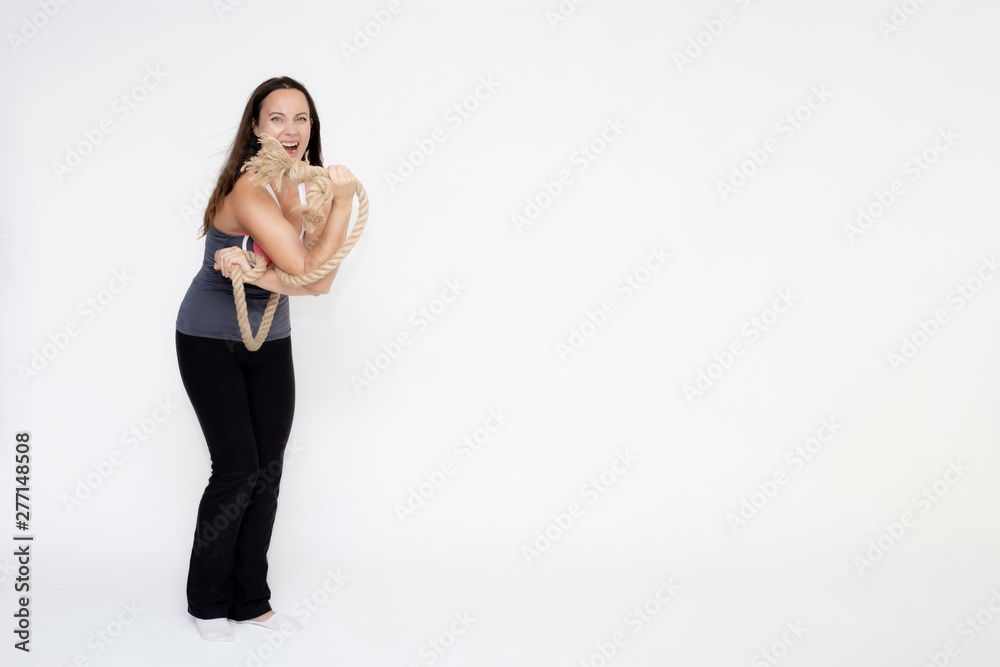 Full-length portrait on white background of beautiful pretty fitness girl woman in sport uniform with rope in hands, with different emotions in different poses. Stylish trendy youth. Full-length portrait on white background of beautiful pretty fitness girl woman in sport uniform with rope in hands, with different emotions in different poses. Stylish trendy youth.
