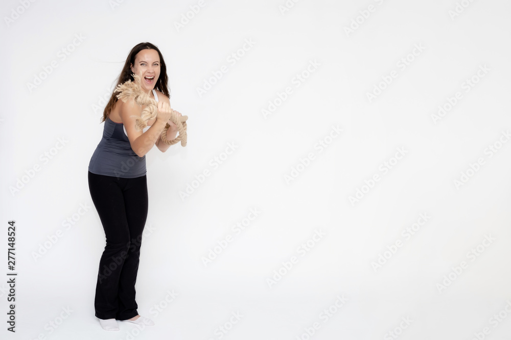 Full-length portrait on white background of beautiful pretty fitness girl woman in sport uniform with rope in hands, with different emotions in different poses. Stylish trendy youth. Full-length portrait on white background of beautiful pretty fitness girl woman in sport uniform with rope in hands, with different emotions in different poses. Stylish trendy youth.