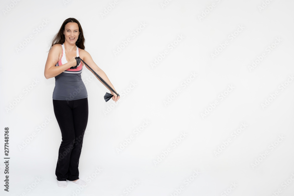 Full-length portrait on white background of beautiful pretty fitness girl woman in sports uniform with rubber expander in hands, with different emotions in different poses. Stylish trendy youth. Full-length portrait on white background of beautiful pretty fitness girl woman in sports uniform with rubber expander in hands, with different emotions in different poses. Stylish trendy youth.