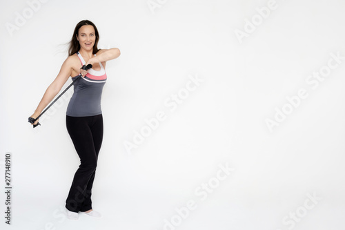 Full-length portrait on white background of beautiful pretty fitness girl woman in sports uniform with rubber expander in hands, with different emotions in different poses. Stylish trendy youth.