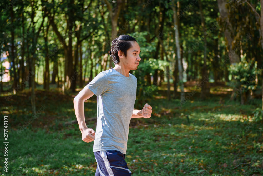 young man runner athlete running in a park young man runner athlete running in a park