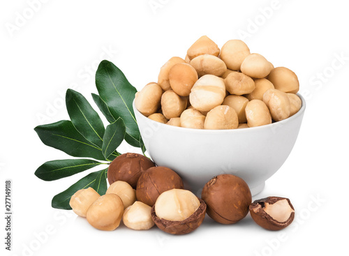 macadamia fruit in the white bowl with leaf isolated on white background
