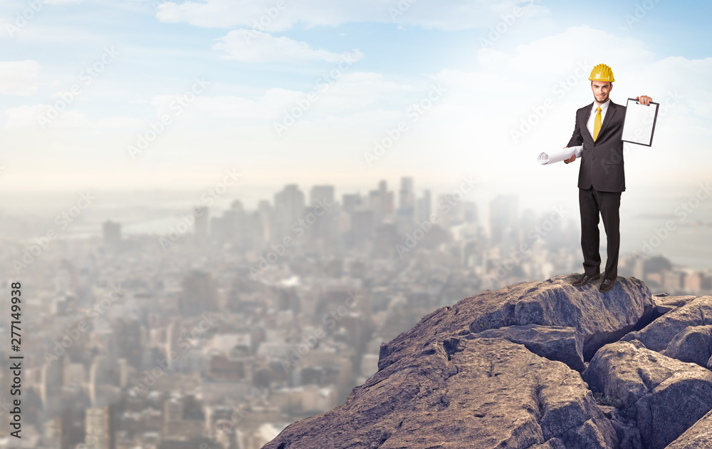 Young business person looking to the city from distance Young business person looking to the city from distance