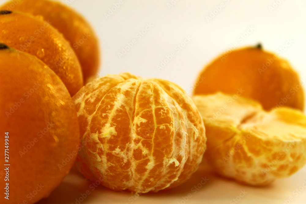 Fresh juicy tangerines lie on a light background Fresh juicy tangerines lie on a light background