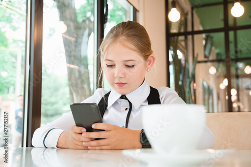 Charismatic girl as a businesswoman in cafe at lunch. Business youth.