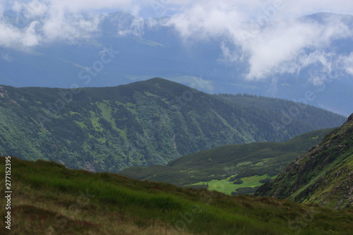 Beautiful green mountains hills and cloudy blue sky