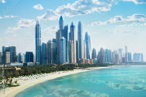 Dubai, UAE United Arabs Emirates. City of skyscrapers, Dubai marina in the sunny day with front line of beach hotels and blue water of Persian gulf  photo