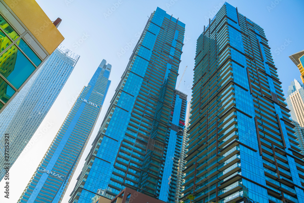 Dubai marina skyscrapers at sunset. View against of blue sky from the Amaar walk. Apartments, hotels and office buildings of UAE Dubai marina skyscrapers at sunset. View against of blue sky from the Amaar walk. Apartments, hotels and office buildings of UAE