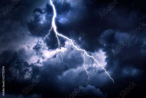 Lightning strike on a cloudy dark rainy sky.