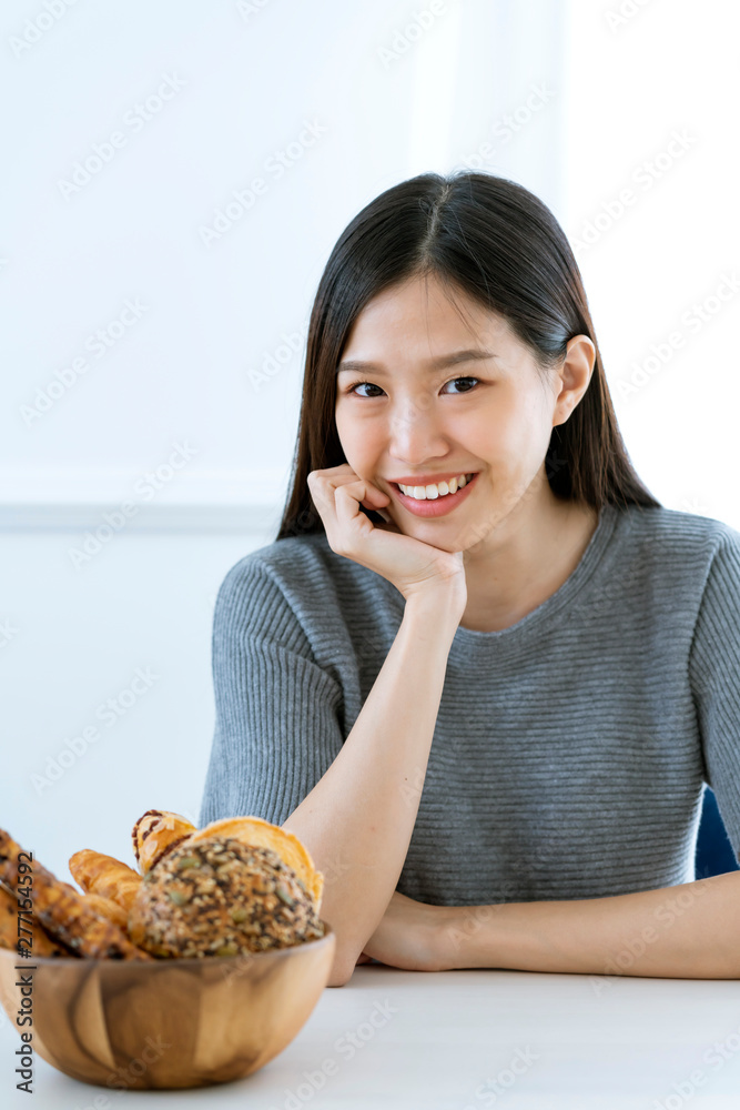 beautiful asian woman casual dress sit and smile with bowl of bread diet food ideas concecpt beautiful asian woman casual dress sit and smile with bowl of bread diet food ideas concecpt