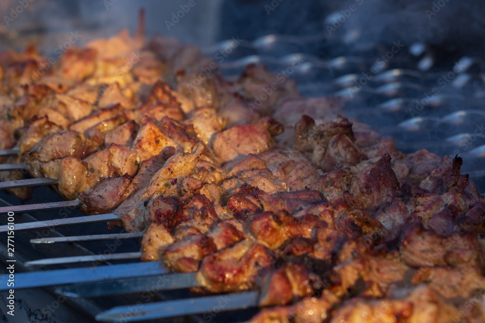 Marinated shashlik preparing on a barbecue grill over charcoal. Shashlik or Shish kebab popular in Eastern Europe. Shashlyk, skewered meat. was originally made of lamb. Marinated shashlik preparing on a barbecue grill over charcoal. Shashlik or Shish kebab popular in Eastern Europe. Shashlyk, skewered meat. was originally made of lamb.