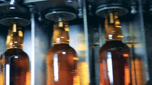 Filled bottles going on a line. Whiskey and brandy distillery photo