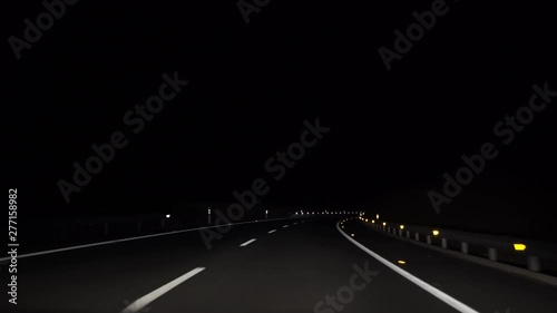 4K, POV view of car driving on road of highway at night in Spain. Drive on an empty road in the dark evening. A car drives on a freeway. Asphalt with white line at new road.-Dan