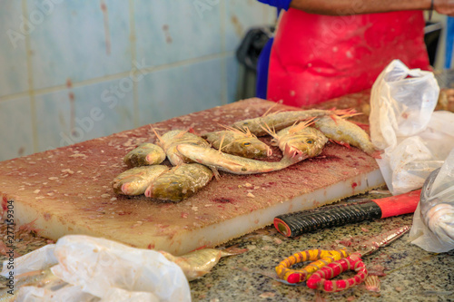 Details of pearly goatfish on wooden cutting board at Al Khor Fish Market in Qatar, Middle East, Arabian Peninsula. photo