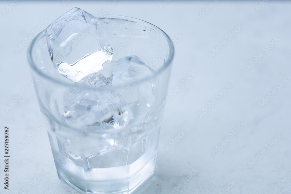 Glass with ice put on table.