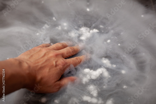 Thick white smoke on a background of black ceramic tiles.