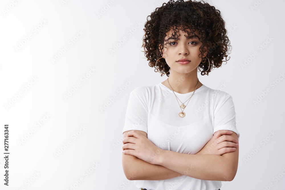 Not your toy. Serious-looking determined assertive good-looking stylish curly hairstyle female cross arms chest confident look camera ready, aim success, believe girl power, white background Not your toy. Serious-looking determined assertive good-looking stylish curly hairstyle female cross arms chest confident look camera ready, aim success, believe girl power, white background