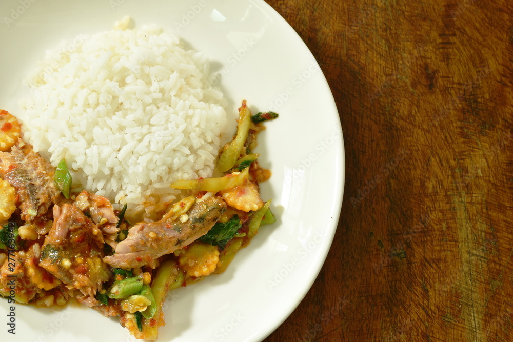 spicy stir fried canned sardines fish with chili and basil leaf on rice spicy stir fried canned sardines fish with chili and basil leaf on rice