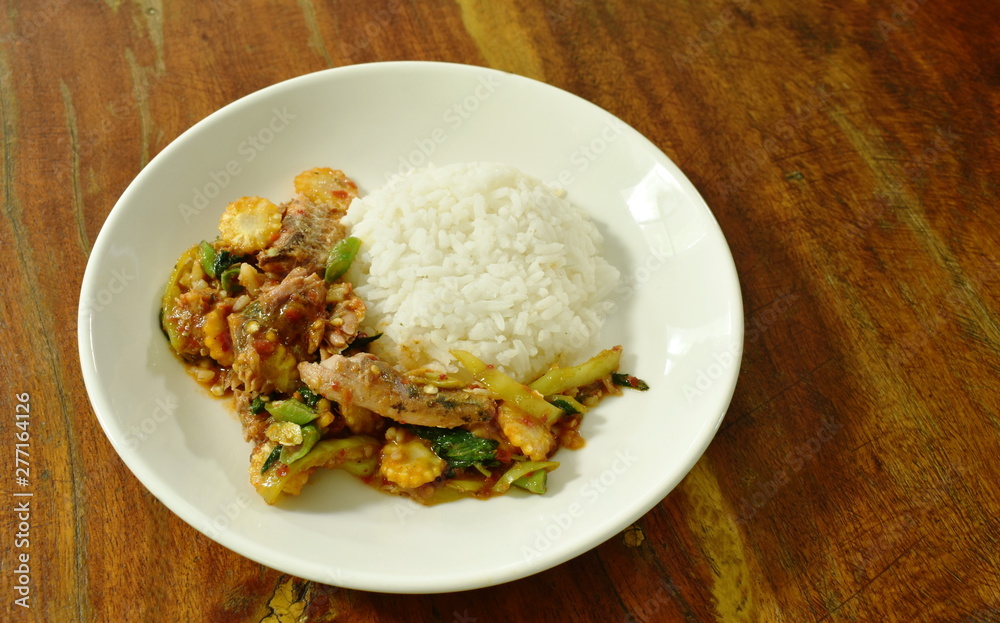 spicy stir fried canned sardines fish with chili and basil leaf on rice spicy stir fried canned sardines fish with chili and basil leaf on rice