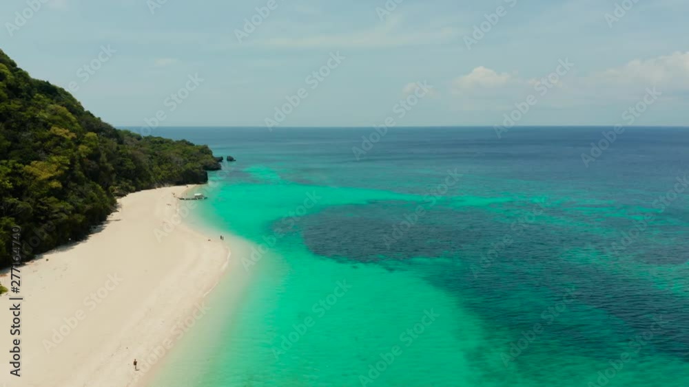 Coast with sandy beach with tourists and clear blue sea top view, Puka shell beach. Boracay, Philippines. Seascape with beach on tropical island. Summer and travel vacation concept.