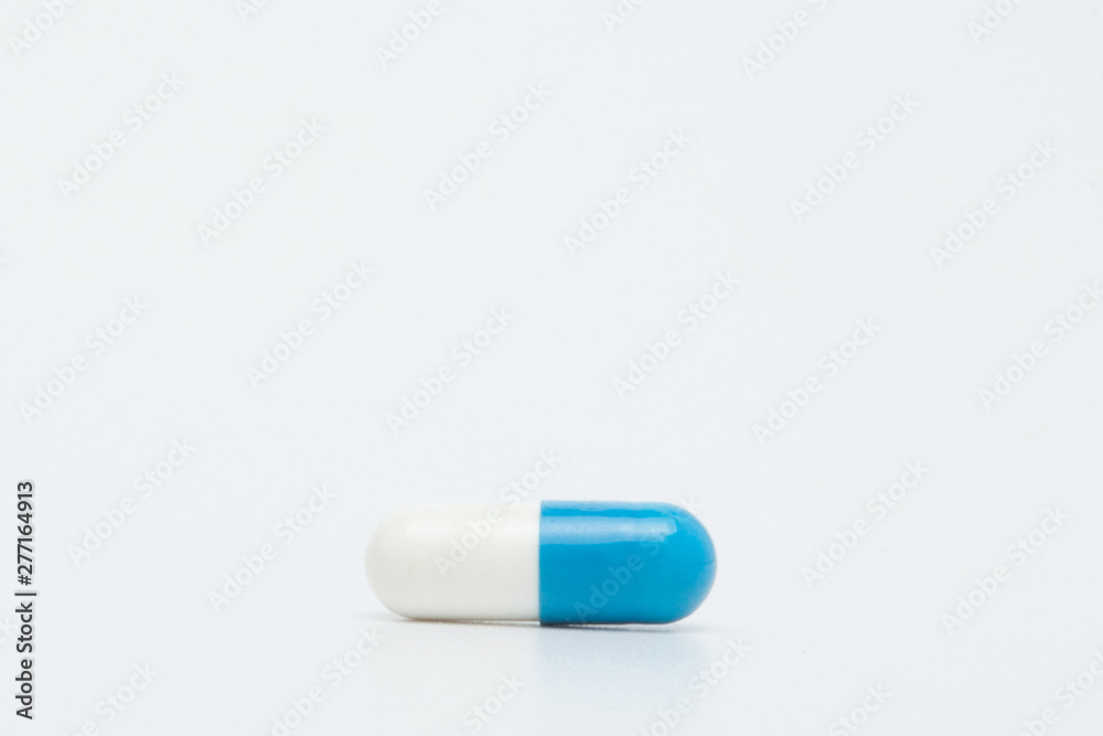 Macro view of blue capsule pill isolated over white background Macro view of blue capsule pill isolated over white background