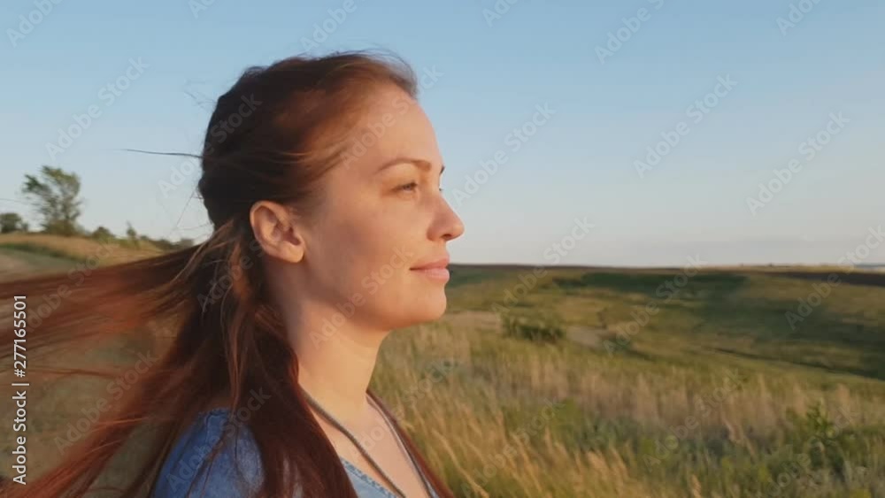 portrait of a woman, lifestyle woman in the evening in the field close-up , the concept of a healthy lifestyle and harmony with nature.