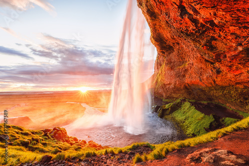 Seljalandsfoss waterfall in Iceland. Amazing Icelandic sunset landscape.