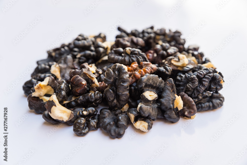 Pile of black walnuts isolated on white background. Pile of black walnuts isolated on white background.