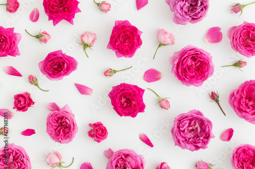 Floral pattern made of pink roses on a white background. Top view.