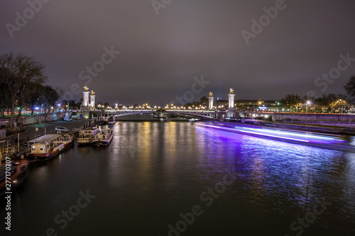 Pont Alexandre III in Paris at night. This bridge is one of the most beautiful and decorated bridges in the world and is located in the Invalides area.