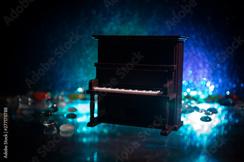 Creative concept. Artwork decoration with piano on dark toned foggy background with light.