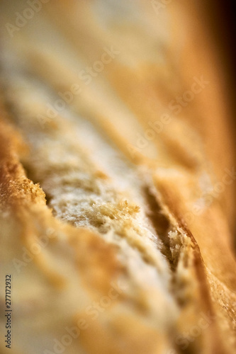 Detailed macro close up shot of french bread baguette out of oven fresh warm cooked baked crunchy crust toast.