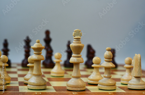  Chess on a chessboard on a gray background. Move e2-e4