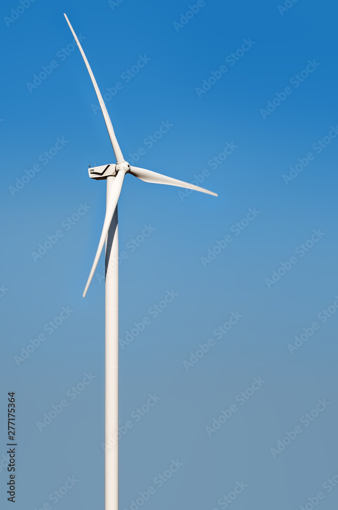 wind turbine isolated against blue sky with slight rotation wind turbine isolated against blue sky with slight rotation