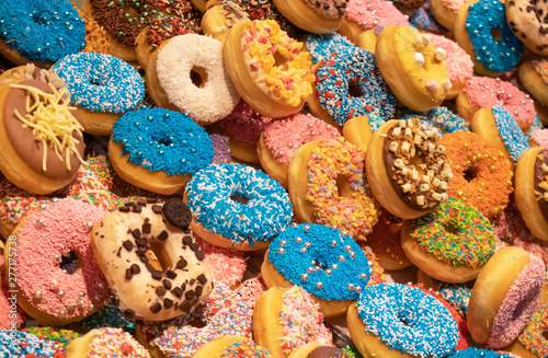 Doughnuts with colorful decoration background. Closeup view