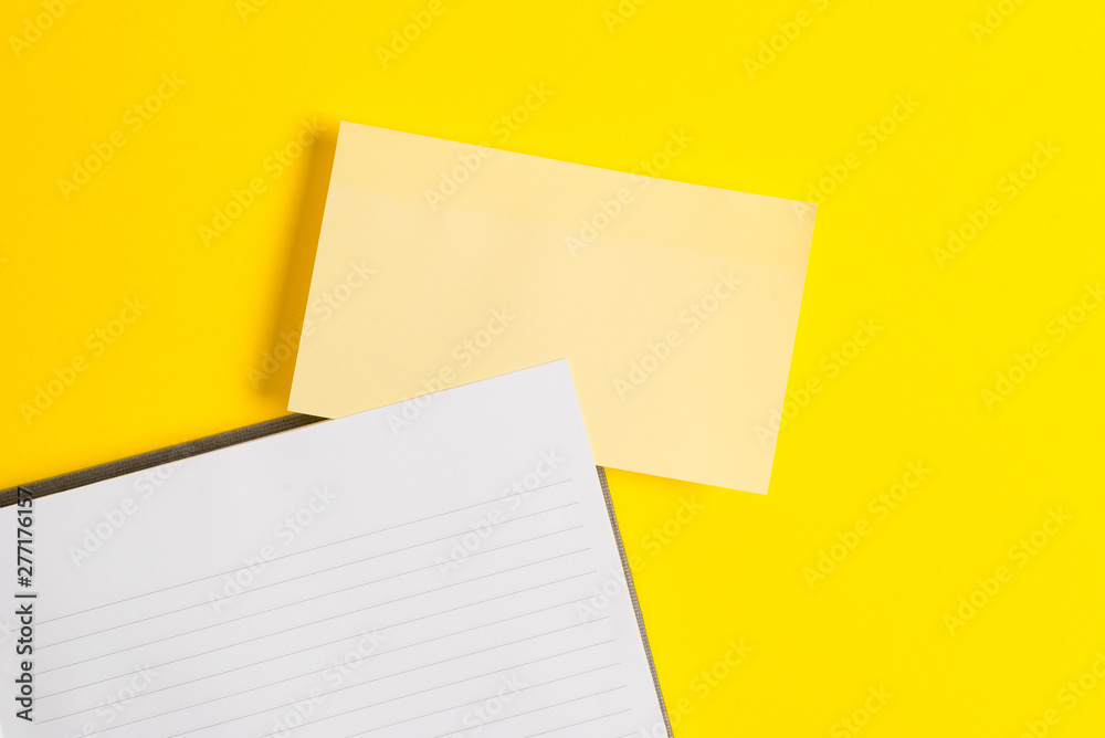 Empty orange paper with copy space on the yellow table. Blank paper for text messages. Empty orange paper with copy space on the yellow table. Blank paper for text messages.