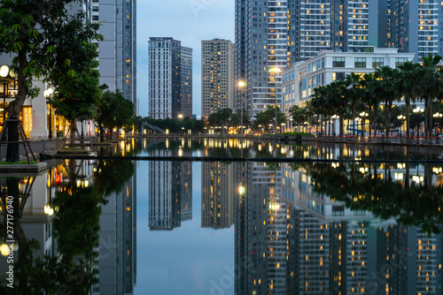 Twilight scene of modern city with buildings and reflection on lake in Hanoi  Vietnam