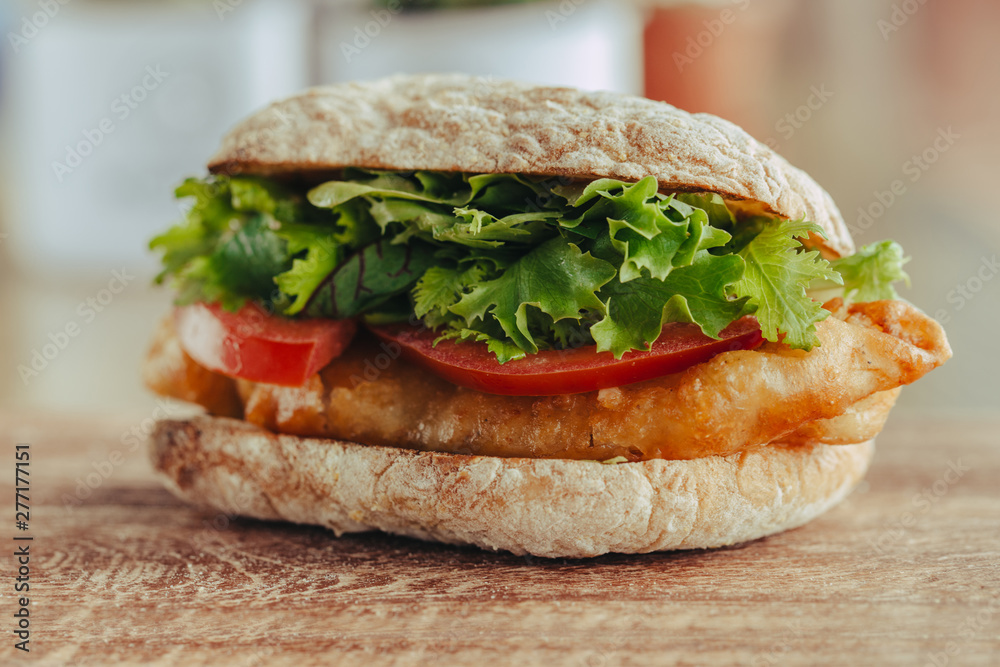 fried fish Sandwich with lettuce, tomato with tartar sauce. author's recipe street food fried fish Sandwich with lettuce, tomato with tartar sauce. author's recipe street food