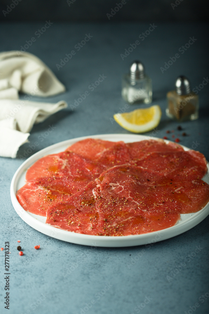 Homemade beef carpaccio with salt and pepper Homemade beef carpaccio with salt and pepper