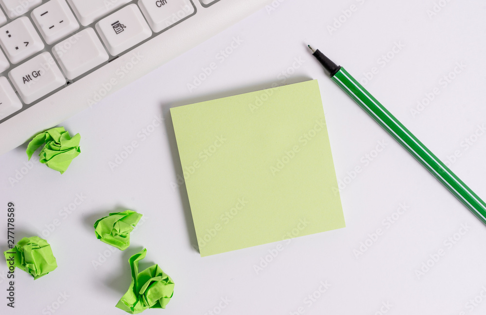Square empty green note paper with pencil on the white background and pc keyboard. Square empty green note paper with pencil on the white background and pc keyboard.