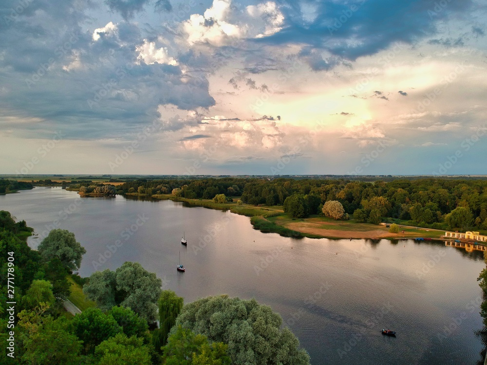 Naklejka premium landscape with river and clouds