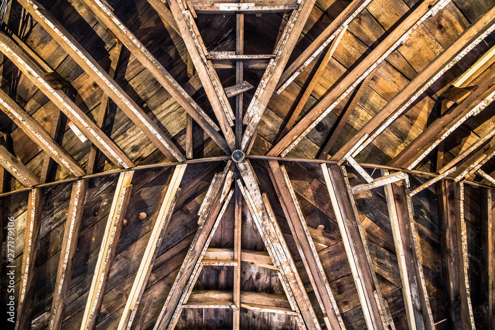 Wooden beam pattern on interior ceiling in rustic barn