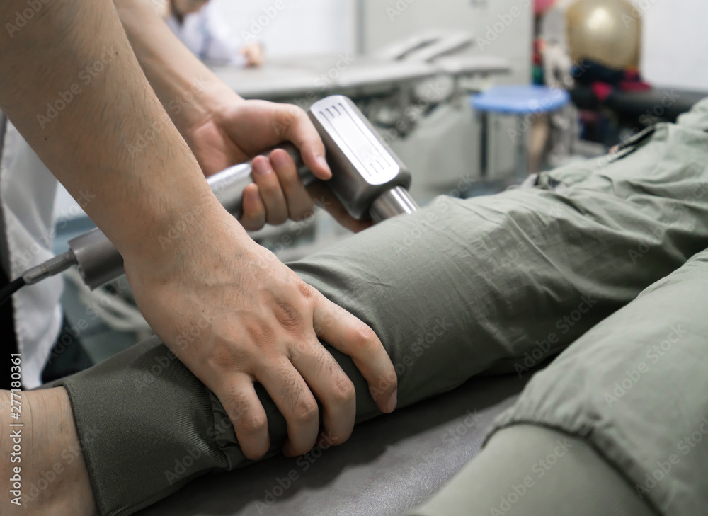 The doctor is rehabilitating the patient's legs The doctor is rehabilitating the patient's legs
