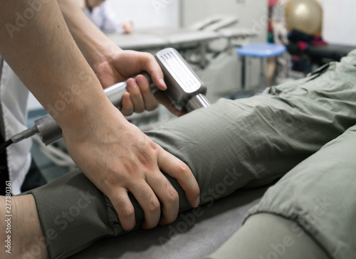 The doctor is rehabilitating the patient s legs