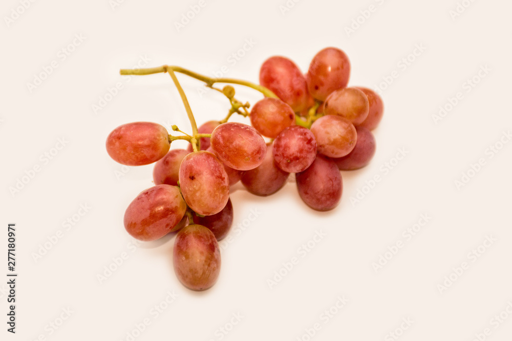 Fototapeta premium Red ripe grapes on neutral background