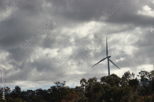 panoramic views of multiple windmills at a modern wind farm built on a green hill on a sunny blue sky cloudy day, Rurul Victoria, near Melbourne photo