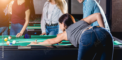 Photos Young woman playing in billiard